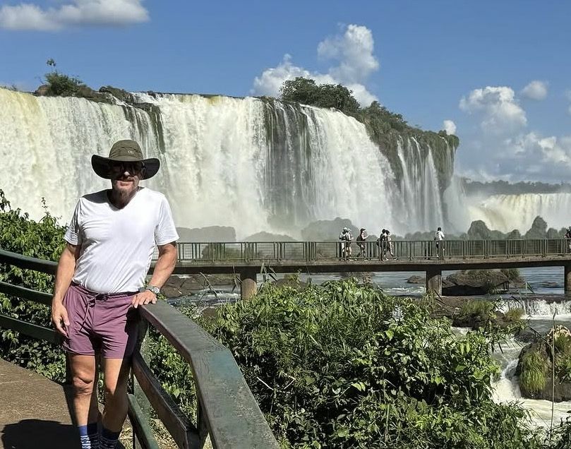 Traveller wearing rain poncho on the boardwalk near Devil's Throat at Iguazú National Park